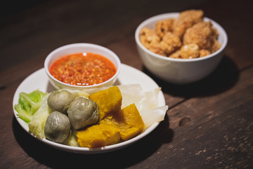 Northern Thai food, many vegetables boiled in a white dish, served with Ong chili paste and pork stick.