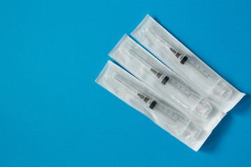 syringe in a blister on a blue background