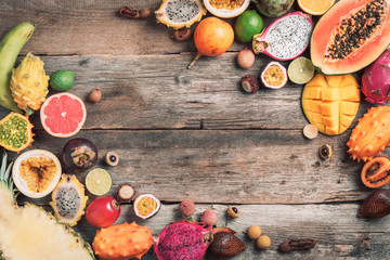 Tropical fruits concept. Exotic fruits - pineapple, papaya, mango, annona, banana, pitahaya, kiwano, african horned melon, tamarillo fruit, granadilla, salak, snake fruit, maracuya, rambutan, lychee