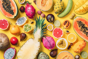 Tropical fruits concept. Exotic fruits - pineapple, papaya, mango, annona, banana, pitahaya,...