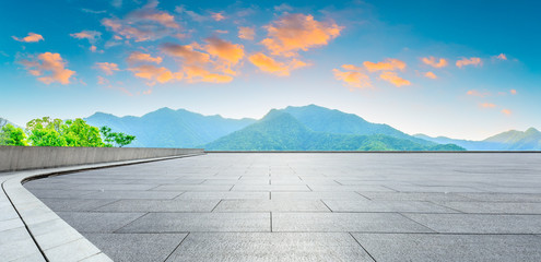 Empty square floor and green mountain nature landscape at sunset,panoramic view.