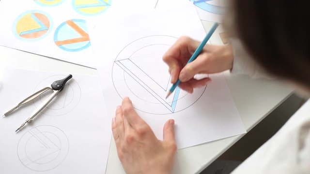 Graphic designer draws a sketch of a brand logo.