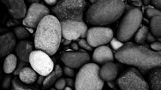 black pebbles on the beach background. black stone - Powered by Adobe