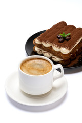 Classic tiramisu dessert on ceramic plate and cup of coffee isolated on white background with clipping path