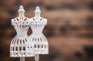 White female vintage Mannequin stand on a wooden background, fashion design concept