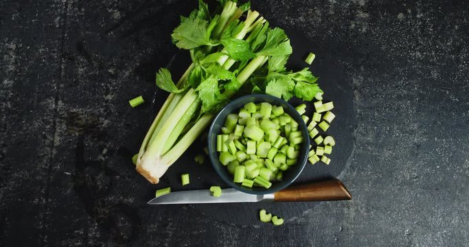 Sliced on a stone Board fresh celery slowly rotates.