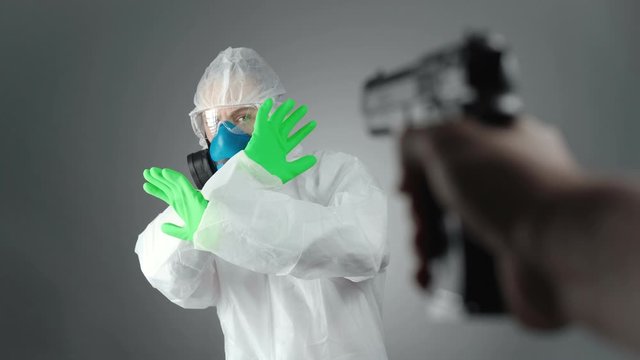 Video of doctor in protective suit with handgun