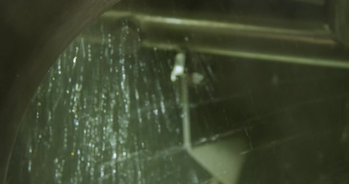 Close up sanitizing Beer brewing tank with agitator rotating