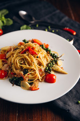 Spicy Drunken Spaghetti. Add ham, garlic, pepper, fresh chilies, baby corn on a white plate. Look from above.