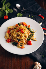 Spicy Drunken Spaghetti. Add ham, garlic, pepper, fresh chilies, baby corn on a white plate. Look from above.