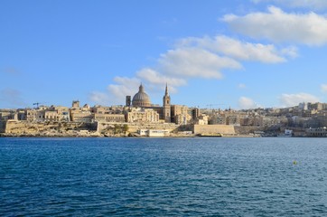 Fototapeta na wymiar The medieval limestone city of Valletta with its main symbols - bell tower of St Paul Pro-Cathedral and large dome of Carmelite church, Malta