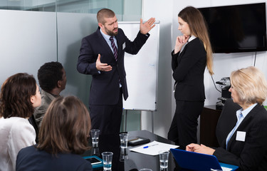 Businessman feeling angry to female coworker in office