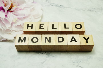 Hello Monday wooden letter alphabet on marble background