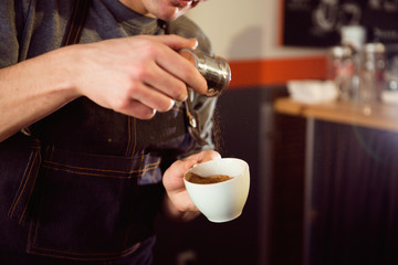 Coffee Latte Barista making pattern in a cup of coffee shop.