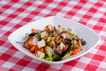 Dietary salad with vegetables, cheese feta, arugula and sauce. Traditional Italian cuisine, Italian concept.