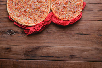 Two pizzas on the dark rustic wooden table. Flat lay, top view. Copy space web design banner.