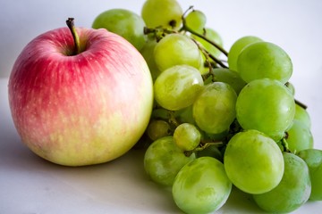 green  grape and apple on white background
