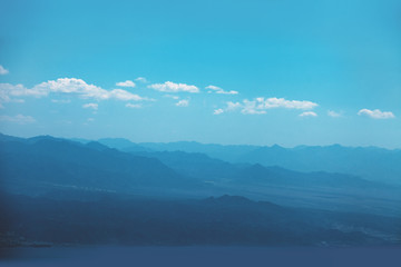 Silhouette of mountains in the early misty morning. Panorama of mountains ridge. Beautiful nature landscape