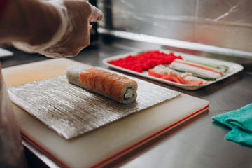 The chef prepares Japanese cuisine rolls