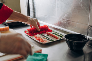 The chef prepares Japanese cuisine rolls