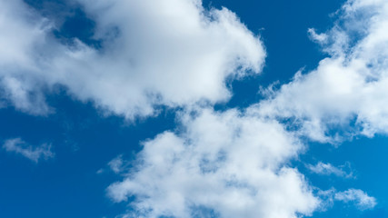 a group of white cumulus clouds in the blue sky as a natural background