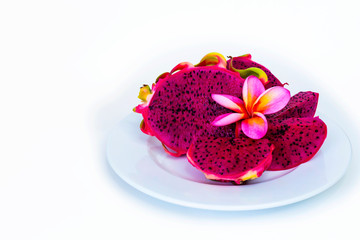 CClose-up of a red Pitaya Tibnoke, in a white dish, top view. Still life with exotic fruits and...
