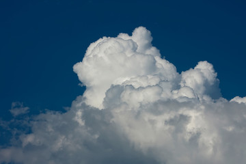 A huge white clA huge white cloud on a beautiful blue and clear skyoud on a beautiful blue and clear sky