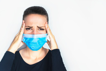 A person suffers from pain because of a severe headache, migraine. Beautiful woman, young annoyed upset man holding his head with hands, temples with fingers looking at camera. Facial expression