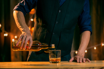 Barman pouring whiskey whiskey glass beautiful night