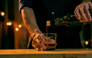 Barman pouring whiskey whiskey glass beautiful night
