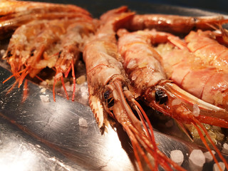 Close up of langoustine with salt on a plate isolated.