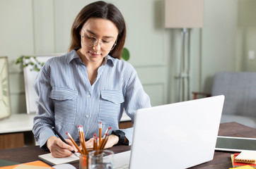 Businesswoman working with laptop at home