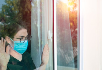 Asian woman wearing a medical mask and quarantine from illness at home. Protection pandemic and...
