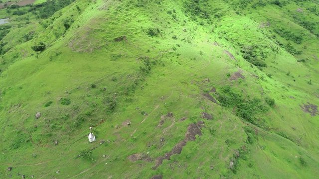 Temple on the hill with fort surrounding in Maharashtra India, aerial travel video while exploring the rural area