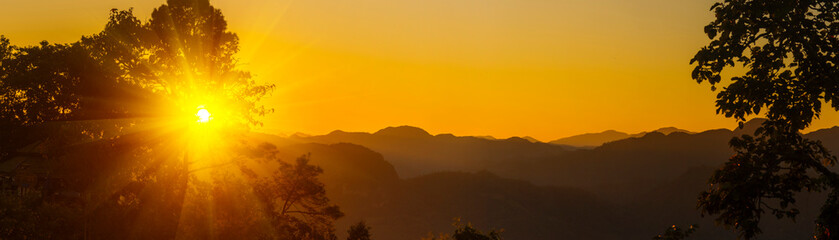 Panorama summer sunset golden cloud summertime light sunny day cloudscape mountain scene. Panoramic sunset golden skyline sun beam over cloud climate background. Heaven gold landscape panoramic banner