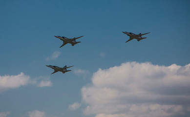 Three planes fly through the blue sky