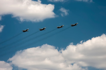 Obraz premium Airplanes fly against the blue sky and white clouds