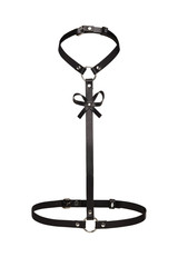 Subject shot of a black leather harness made of straps with rivets, steel rings and a leather bow. The chest harness is isolated on the white background.  