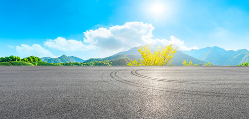 Race track road and green tea mountain on a sunny day,panoramic view.