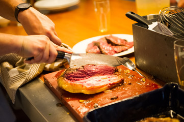 Roasted meat is being cut for serving. Cooking class in Amsterdam.