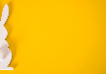 White Easter bunny on yellow background. Easter background