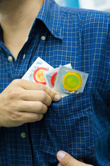 Young men carry condoms for safe sex. The concept of safe sex.