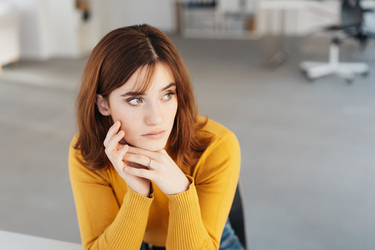 Worried Young Woman Sitting Looking Aside