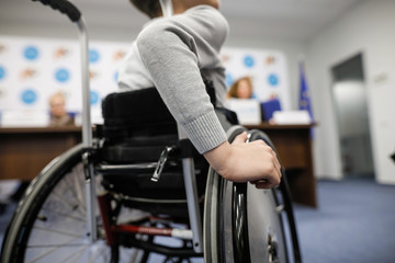 Details of an ill disabled young boy in a wheelchair.