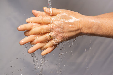 Fototapeta premium Using soap and water to wash away covid-19 or coronavirus