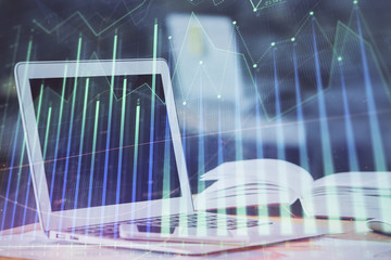 Forex graph hologram on table with computer background. Double exposure. Concept of financial markets.
