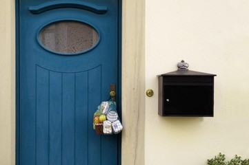 delivery during the quarantine. Shopping bag with Merchandise, goods and food is hanging at the...