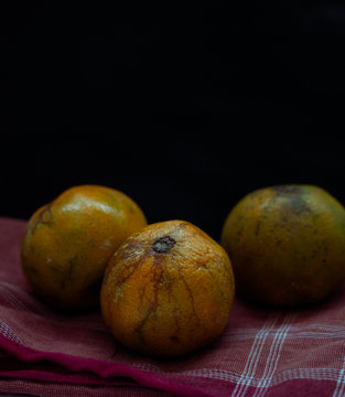 Oranges that have dried up on a dark background.