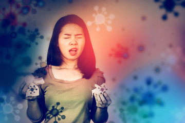sick Asian woman suffering from covid 19 virus hand holding paper tissue and sneezing or coughing...