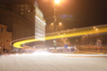 Empty wooden surface and blurred view of night city